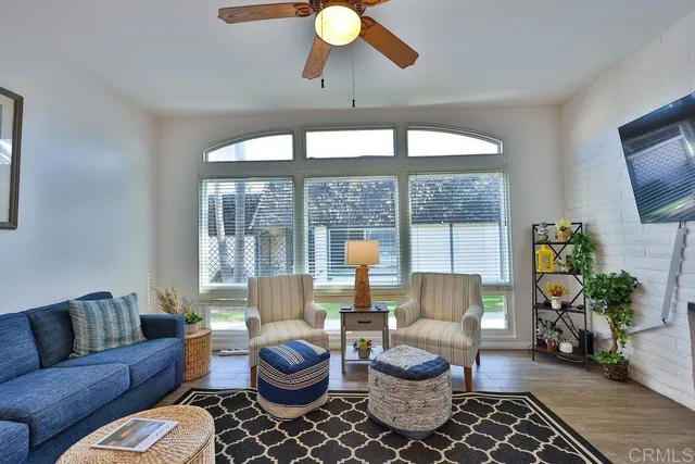 a living room with furniture a flat screen tv and a fireplace