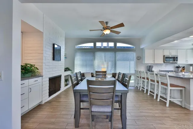 a dining room with furniture and wooden floor
