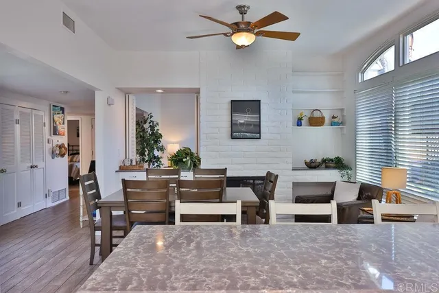 a bedroom with two beds and ceiling fan