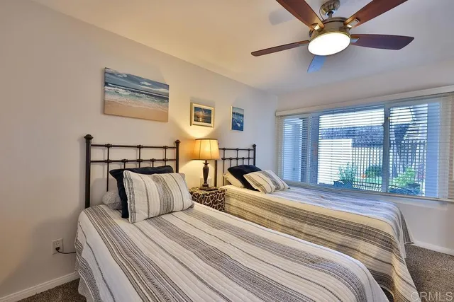 a bedroom with furniture and a large window