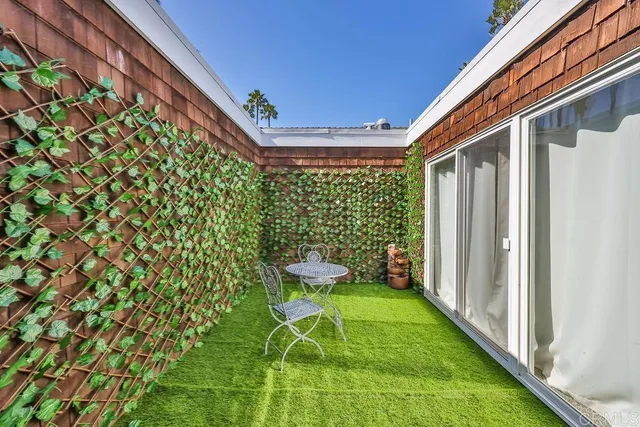 a view of a porch with a table and chairs