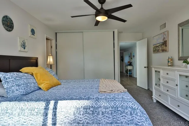 a spacious bathroom with a granite countertop sink a toilet and a mirror