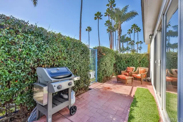 a front view of a house with a yard and potted plants