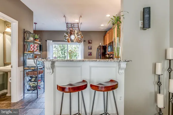 a kitchen with stainless steel appliances a table and chairs in it