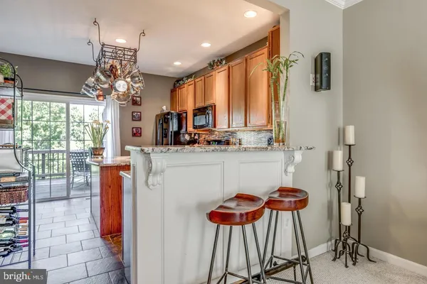 a kitchen with stainless steel appliances a table chairs and a chandelier