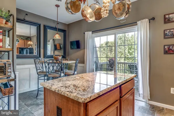 a view of a dining room and kitchen with a table chairs