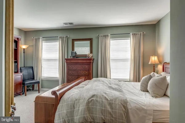 a bedroom with a large bed and a window