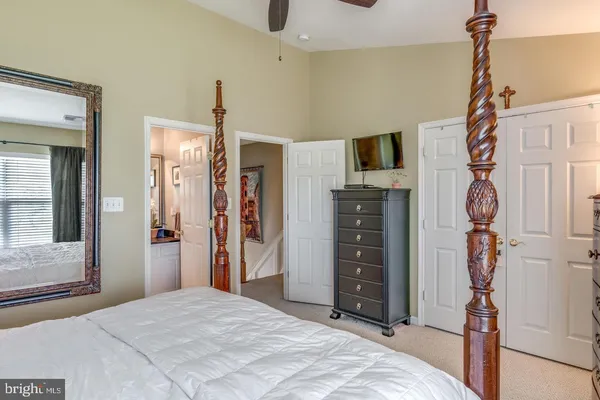 a bedroom with a bed and a flat tv screen
