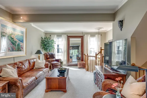 a living room with furniture fireplace and a large window