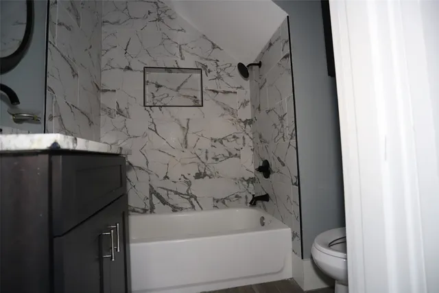 a bathroom with a bathtub and a toilet