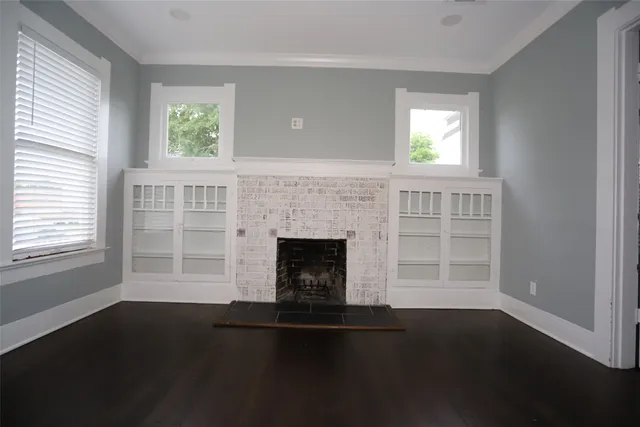 a living room with a fireplace and a window
