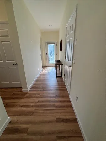 a view of a livingroom with wooden floor and stairs