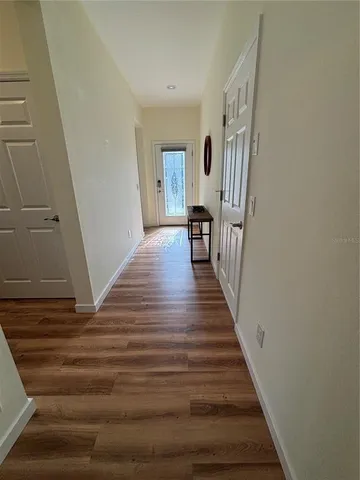 a view of a livingroom with wooden floor and stairs
