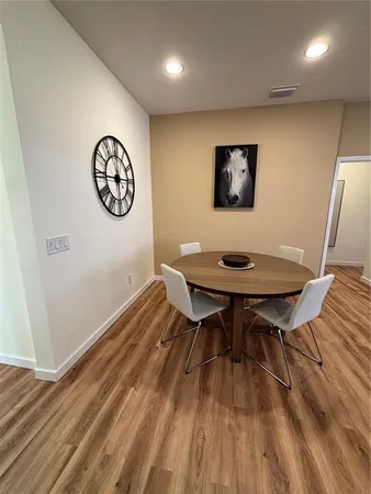 a view of a workspace room with wooden floor