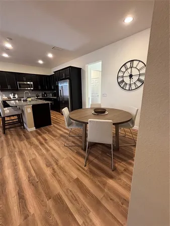 a kitchen with a table and chairs in it