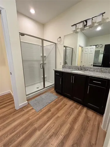a spacious bathroom with a shower and a sink