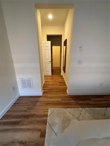 a view of a hallway view with wooden floor and staircase