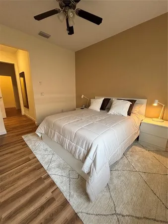 a bedroom with a bed and a flat screen tv