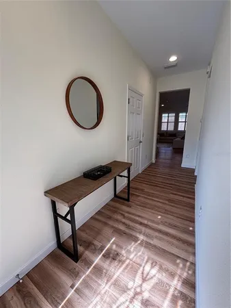 a room with wooden floor and furniture