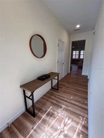 a room with wooden floor and furniture
