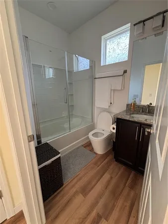 a bathroom with a bathtub sink mirror and toilet