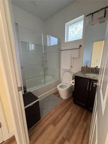 a bathroom with a bathtub sink mirror and toilet
