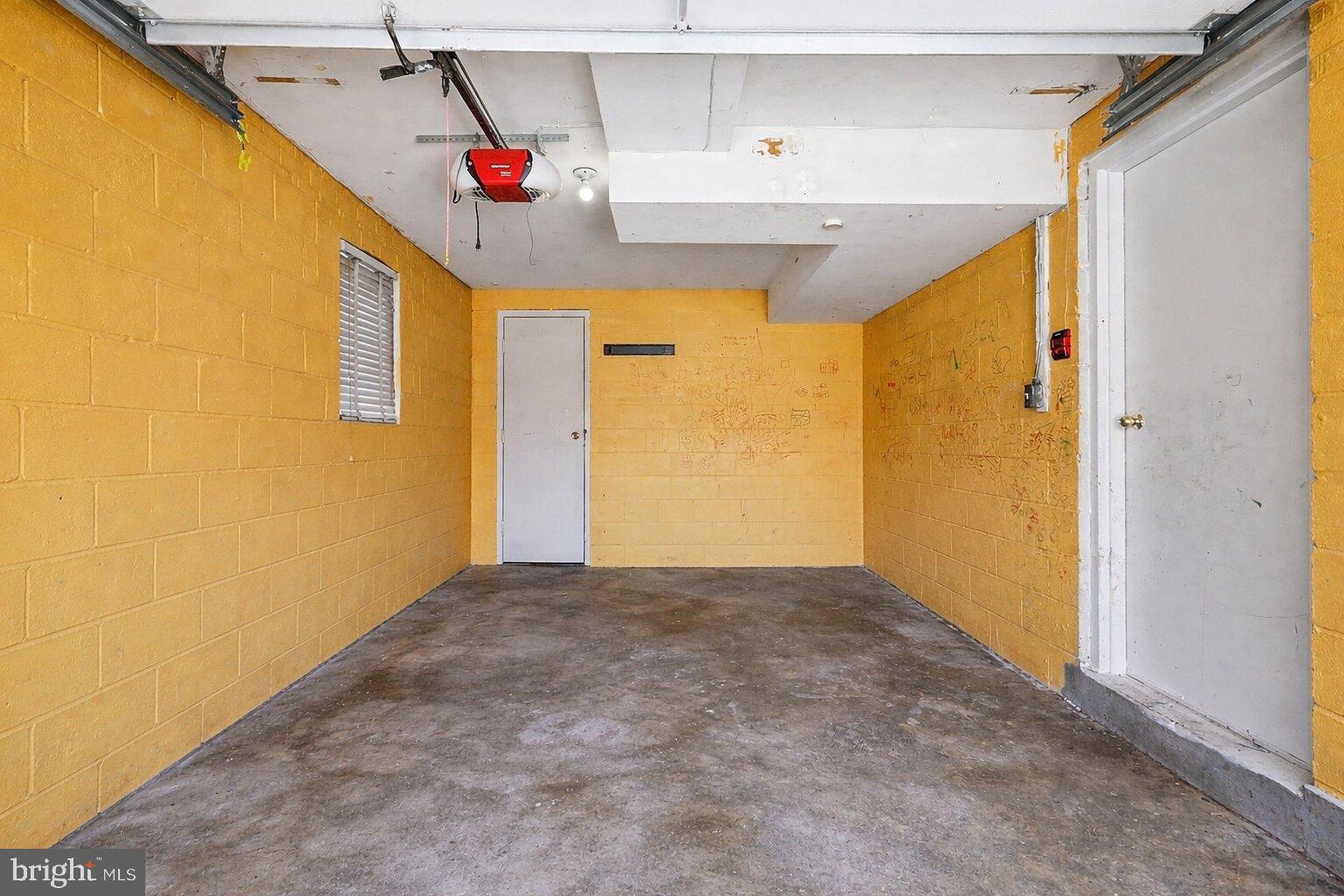 2402 24th Street Southeast Washington, DC 20020 - Photo 16 of 41 Bright and spacious garage with yellow walls.