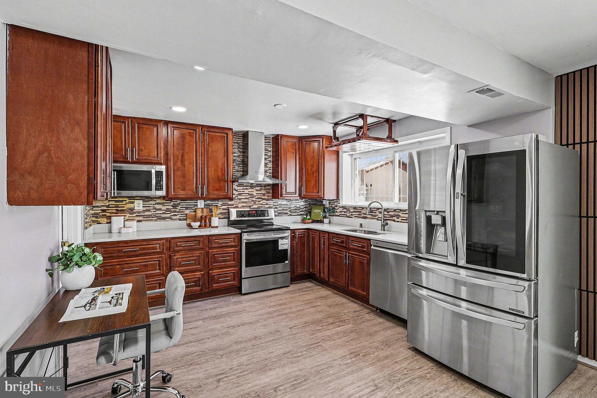 2402 24th Street Southeast Washington, DC 20020 - Photo 3 of 41 Modern kitchen with rich wood cabinetry.