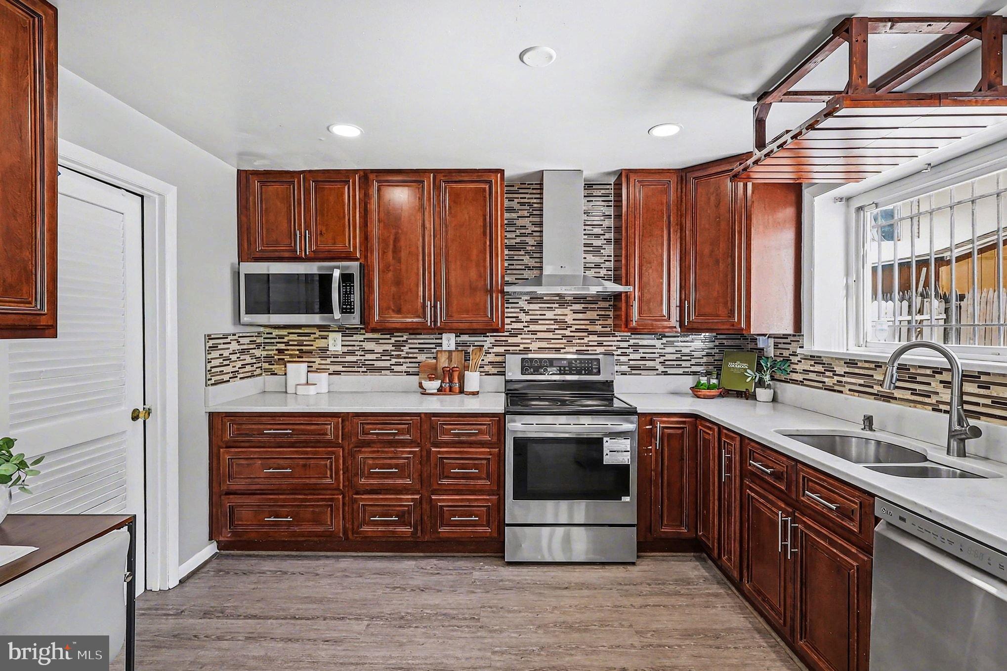 2402 24th Street Southeast Washington, DC 20020 - Photo 4 of 41 Modern kitchen with rich wood cabinetry.