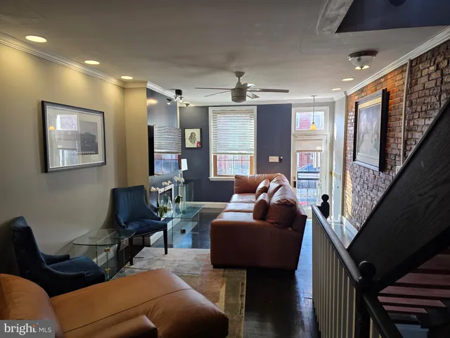 a view of a livingroom with workspace and a flat screen tv