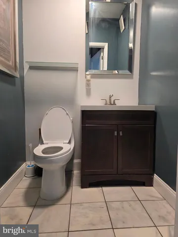 a bedroom with a bed a table and chair