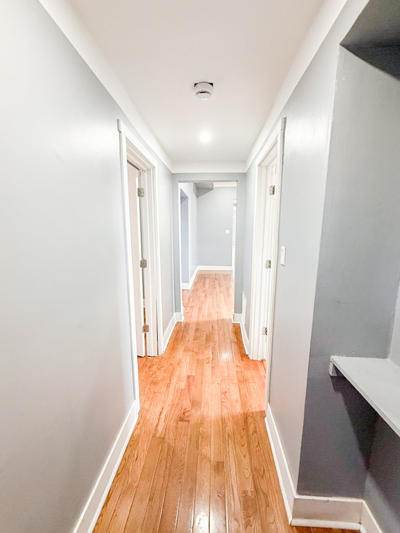 438 East 49th Street, Unit 3 Chicago, IL 60615 - Photo 14 of 18 a view of a room with wooden floor and staircase