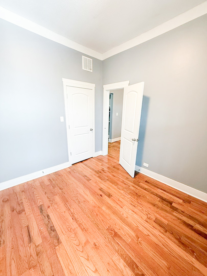 438 East 49th Street, Unit 3 Chicago, IL 60615 - Photo 15 of 18 a view of empty room with wooden floor