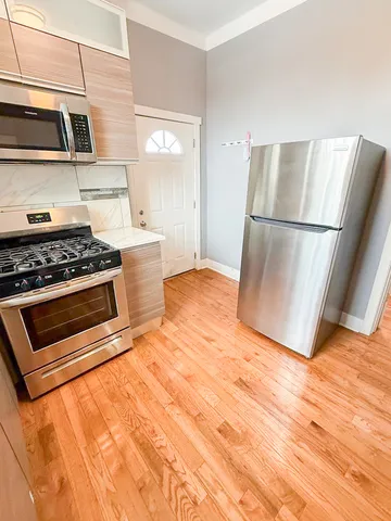 a kitchen with a stove and a refrigerator