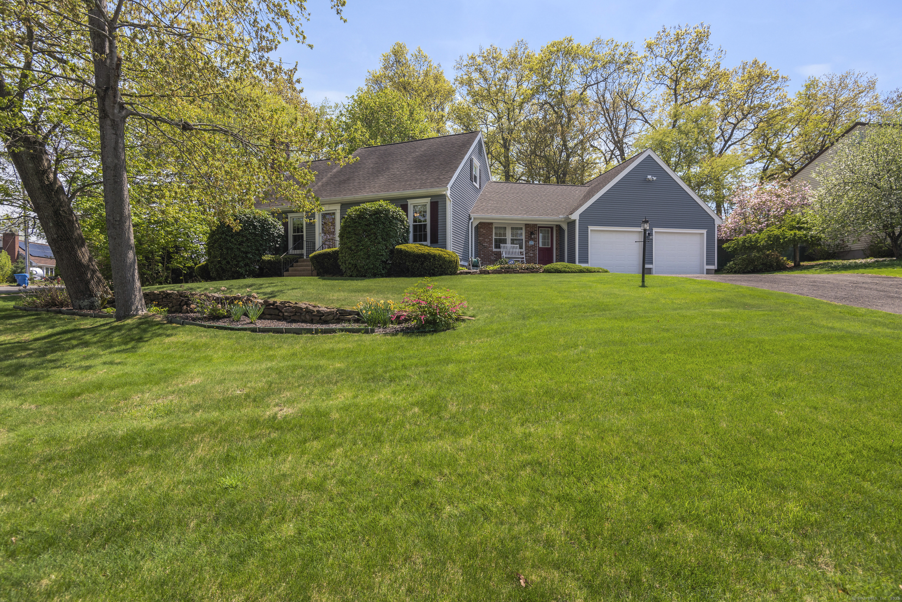 a front view of house with yard and trees