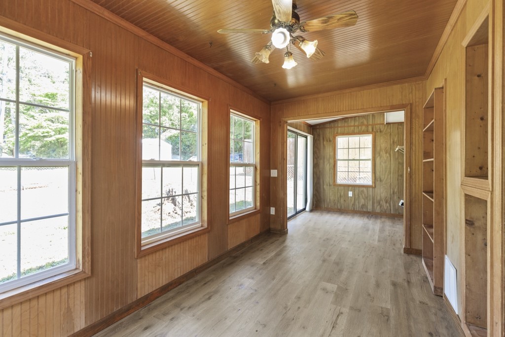 104 Doyle Drive Seneca, SC 29678 - Photo 6 of 19 This bright sunroom features rich wood paneling, ample natural light, and durable vinyl flooring.