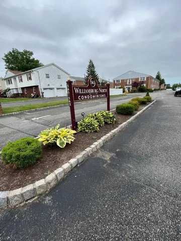 a view of a street with cars parked