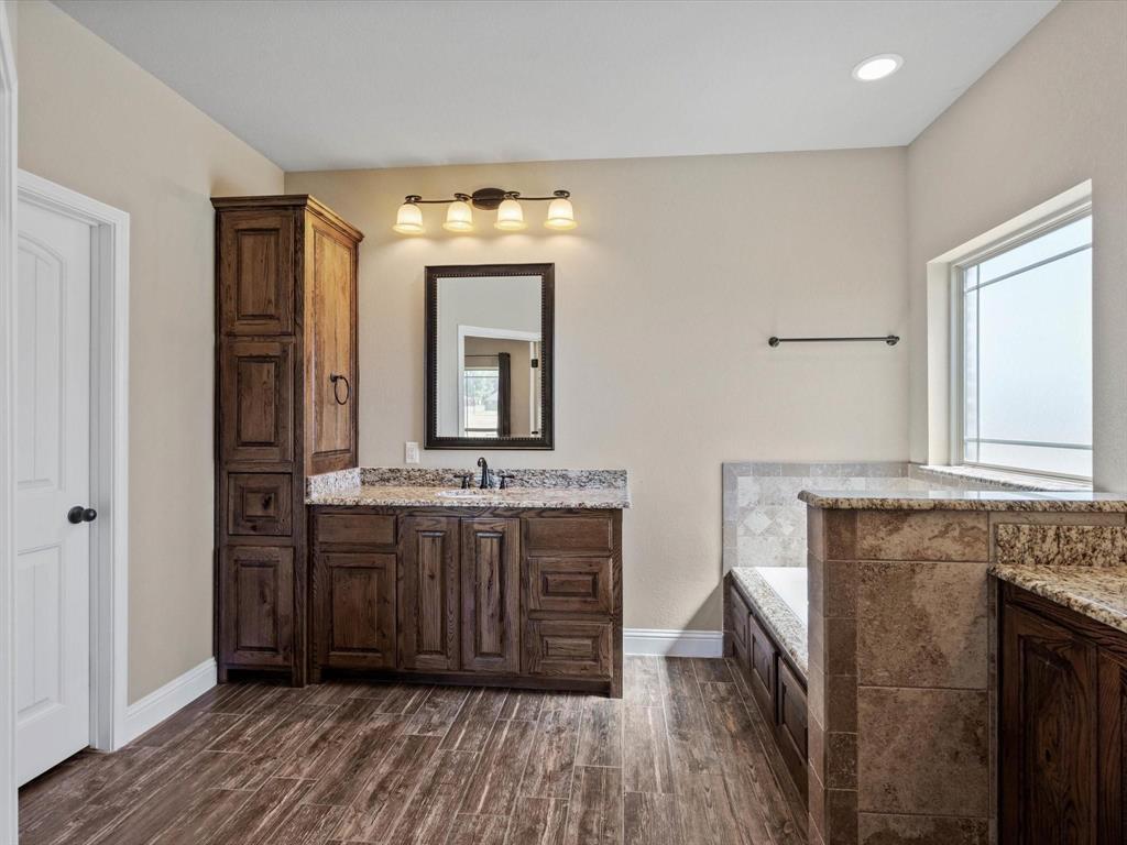 229 Etta Lane Springtown, TX 76082 - Photo 27 of 39 a bathroom with a granite countertop sink and a mirror