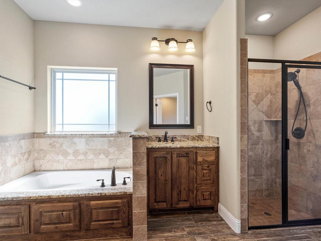 229 Etta Lane Springtown, TX 76082 - Photo 28 of 39 a bathroom with a sink and a mirror