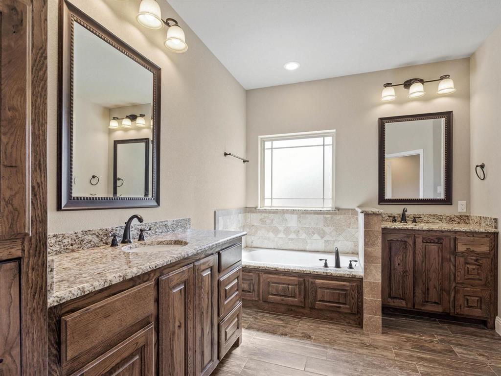 229 Etta Lane Springtown, TX 76082 - Photo 29 of 39 a bathroom with double vanity sinks and a mirror