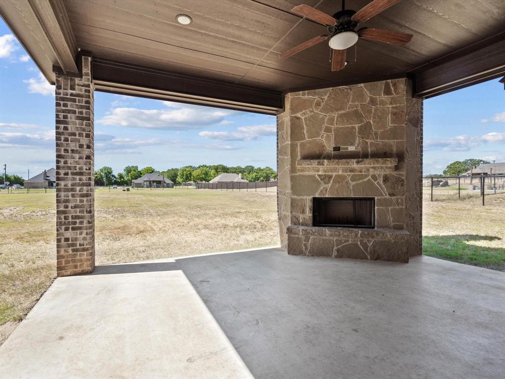 229 Etta Lane Springtown, TX 76082 - Photo 34 of 39 a view of a porch with a table and a fireplace