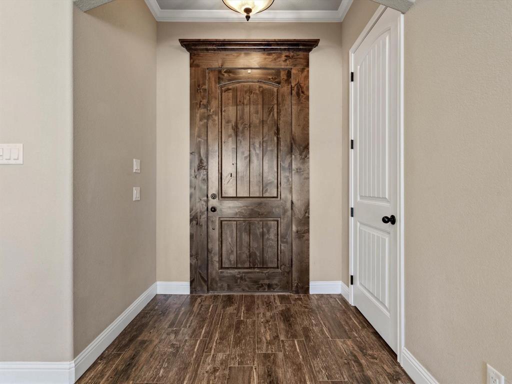 229 Etta Lane Springtown, TX 76082 - Photo 6 of 39 a view of a hallway with wooden floor