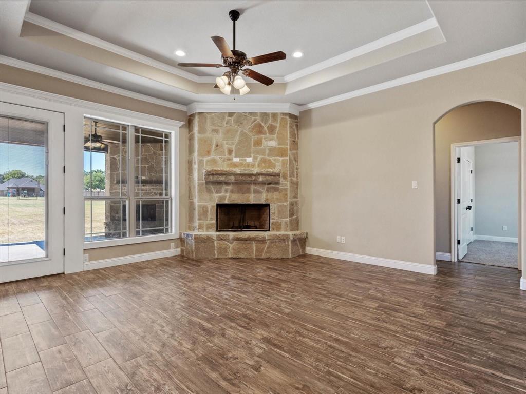 229 Etta Lane Springtown, TX 76082 - Photo 7 of 39 a view of an empty room with a window and wooden floor