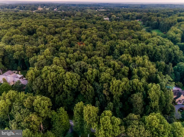 an aerial view of a houses with a yard