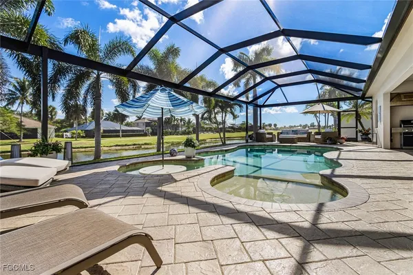 an aerial view of a house with a garden and lake view