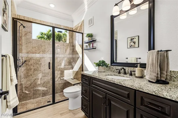 a spacious bathroom with a granite countertop tub sink a mirror and a shower