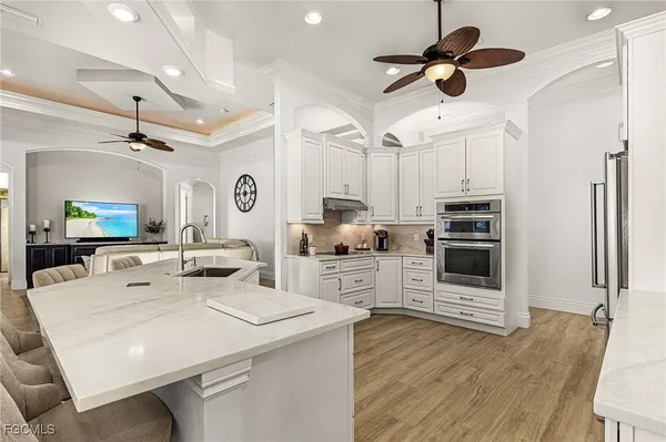 a dining room with furniture a rug and a floor to ceiling window