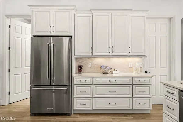 a dining room with furniture a rug and a floor to ceiling window