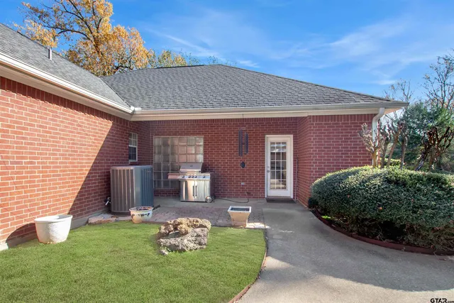 a front view of a house with a garden and yard