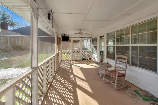 a view of a balcony with table and chairs